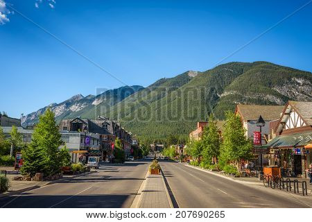 BANFF, ALBERTA, CANADA - JUNE 27, 2017 :  Scenic street view of the Banff Avenue in a sunny summer day. Banff is a resort town and popular tourist destination.