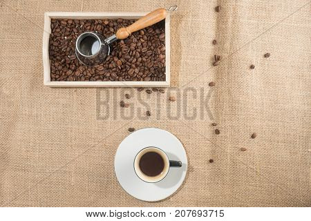 Top horizontal view of coffeepot and coffee gezva and coffee box with brown coffee beans