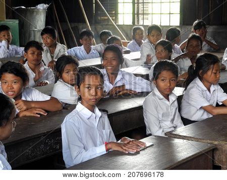 Seam Reap, Cambodia: October 08, 2012: Cambodian students at their desk. The school is named New Bridge for Cambodia and is an organization that offers students free education.
