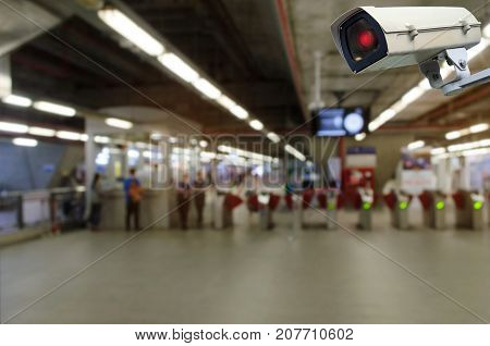 CCTV security indoor camera system operating with blurred image of entrance of subway or railway at train station transportation surveillance security and safety technology concept