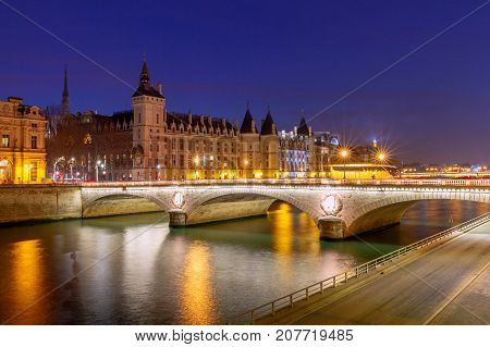 Embankment along the Conciergerie and the river Seine at night. Paris. France.