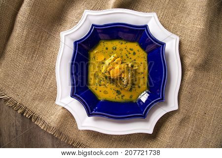 Pequi Fruit With Chicken Over A Wooden Table. Frango Com Pequi.