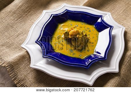 Pequi Fruit With Chicken Over A Wooden Table. Frango Com Pequi.