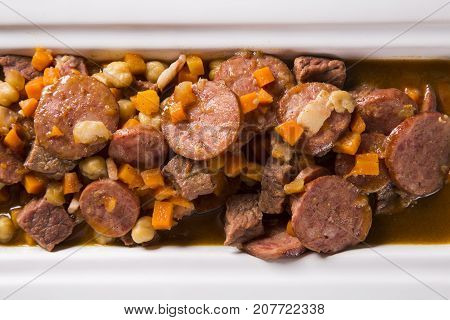 South American Cuisine: Puchero Soup With Sausage. Close-up In A Pot On The Table.