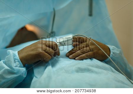 The patient lies on the operating table