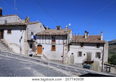Nice facades in steep alley. The mountain village - about 1400 m above sea - Pescocostanzo in the region of Abruzzo Italy
