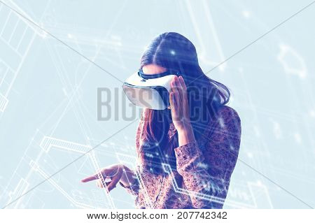 Young woman with virtual reality glasses. The concept of future technology. The concept of a remote study.