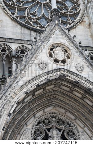 Front entrance of old stone cathedral with architectural details.