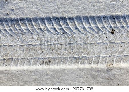 Dirty Yellowish Snow Lying On The Road In The Winter Season. Close-up Photo