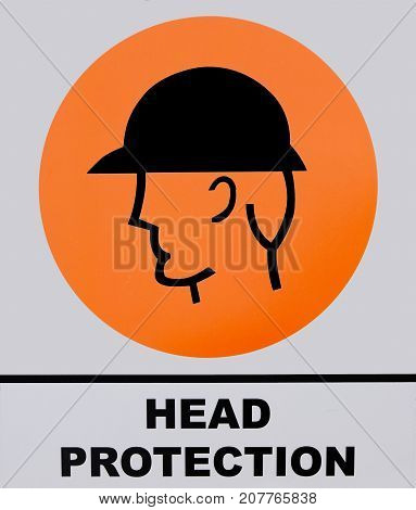 Photo of Head Protection sign on white and orange background.