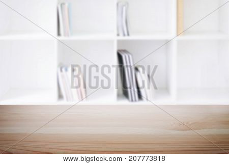 Empty wooden table and blur background of abstract in front of modern library or knowledge source can be used Mock up for display of product or for montage.