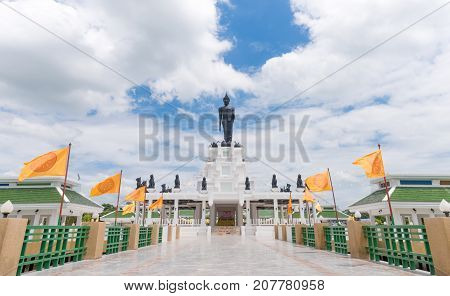 Black Big Buddha Statue With White Cloudy And Blue Sky