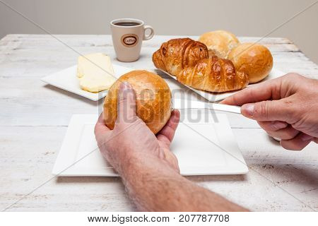 an Hard roll call it in Dutch Pistolee and croissant whit knife and butter