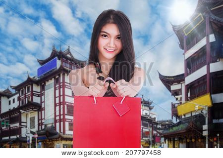 Chiness lady in cheongsam dress with shopping bag on Shanghai vintage building and street Shang hai city China