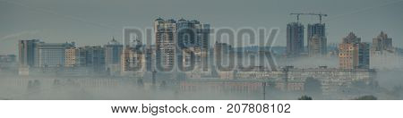Overpopulation concept - construction of new block bulidings, fog, toned, Kyiv, Ukraine