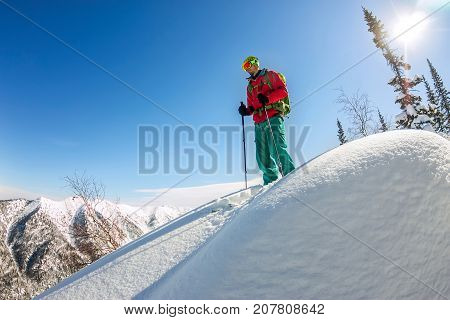 Man Standing At Top Of Ridge. Ski Touring In Mountains. Adventure Winter Freeride Extreme Sport