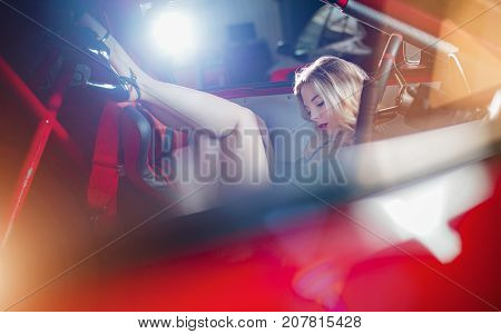 Sensual girl at the wheel of a sports car.