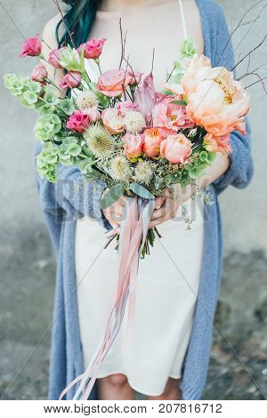 Woman holding a decorative bouquet in outdoor