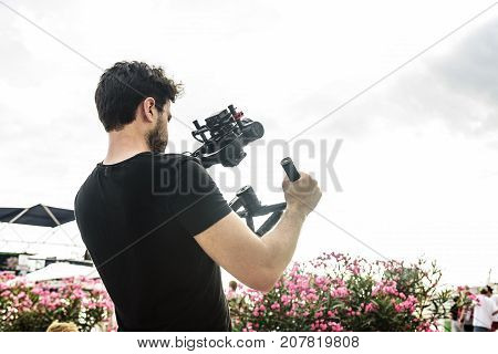 SPLIT, CROATIA - 13 JULY, 2017: Cameraman shoots video at the camera using a shoulder steadicam