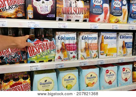 GRAND EST, FRANCE - AUGUST 16, 2017: Several brands of beer in an alcoholic beverage aisle of a french Super U supermarket.