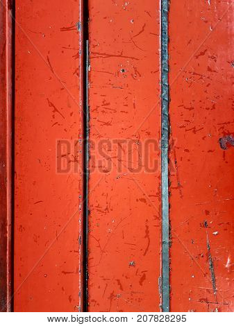 Old red wooden planks weathered from a bench
