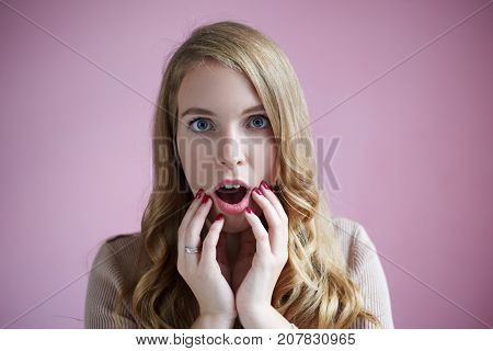 Awe wonder shock and surprise. Headshot of emotional cute young woman with popped eyes and jaw dropped staring at camera in full disbelief loss for words because of shocking unexpected news