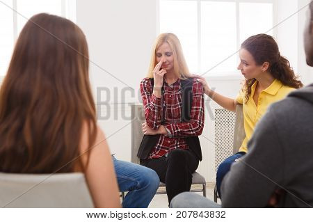 Meeting of support group. Young despaired woman crying during rehab group therapy. Psychotherapy, depression, life issues concept