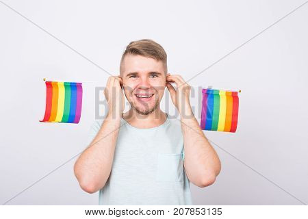 Young man hold a rainbow flag, gey boy.