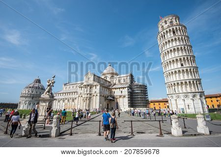 PISA, ITALY - SEPTEMBER 20, 2014: The world famous Piazza dei Miracoli in Pisa, Tuscany. The construction of the cathedral was begun in 1064.