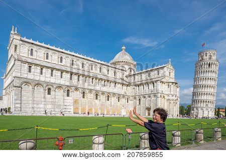 PISA, ITALY - SEPTEMBER 20, 2014: The world famous Piazza dei Miracoli in Pisa, Tuscany. The construction of the cathedral was begun in 1064.