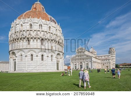 PISA, ITALY - SEPTEMBER 20, 2014: The world famous Piazza dei Miracoli in Pisa, Tuscany.  The construction of the cathedral was begun in 1064.