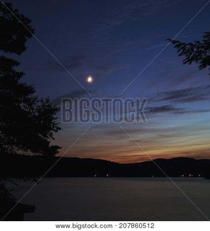 Small crescent moon over Squam Lake, New Hampshire, after sunset