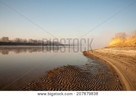 Morning on the river early morning reeds mist fog and water surface on the river