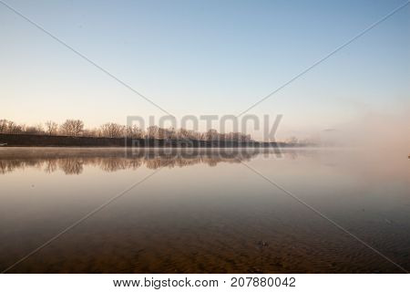 Morning on the river early morning reeds mist fog and water surface on the river