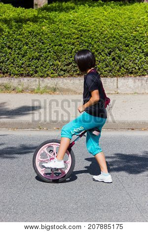 OSAKA JAPAN - SEPTEMBER 18 : unidentified asian little girl starting riding a unicycle (one wheel bike) in a park on September 18 2017 in Osaka Japan.