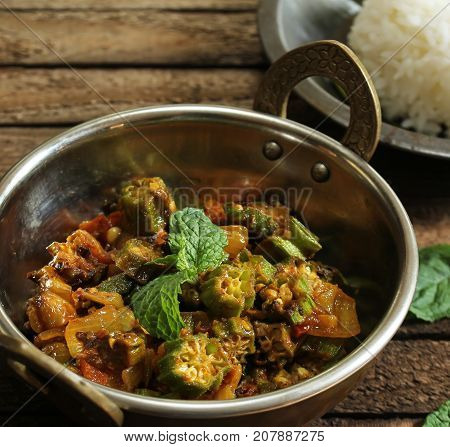 Bhindi Masala or Fry / Okra cooked with onions tomatoes and spices selective focus