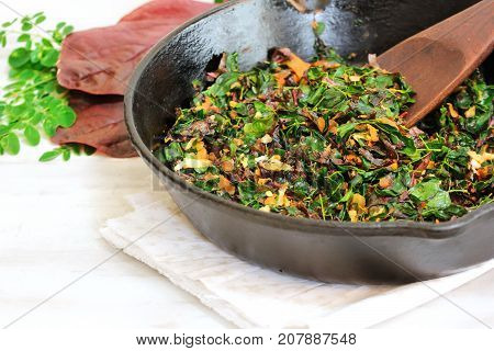 Moringa red Spinach stir fry/ Cheera Drumstick leaves Thoran selective focus