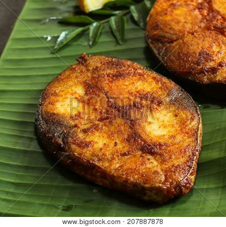Close up of fried King Fish on banana leaf selective focus