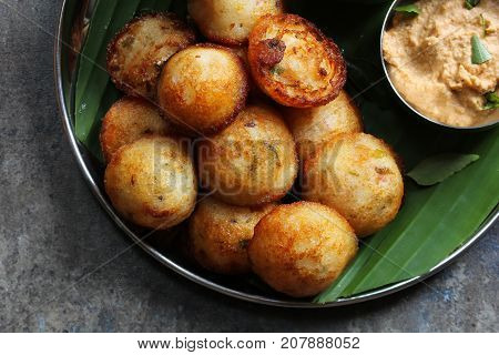 Kuzhi Paniyaram served with coconut chutney and sambar- South Indian breakfast with black lentils and rice