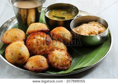 Kuzhi Paniyaram served with coconut chutney and sambar- South Indian breakfast with black lentils and rice