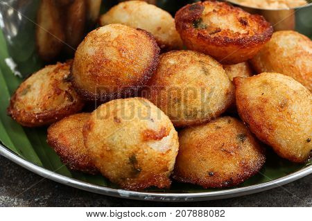 Kuzhi Paniyaram served with coconut chutney and sambar- South Indian breakfast with black lentils and rice