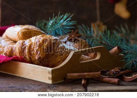 Christmas and New Year 2017 background with continental breakfast - cinnamon fresh orange and croissant. Decorations - snowflake crochet napkin pine cones.