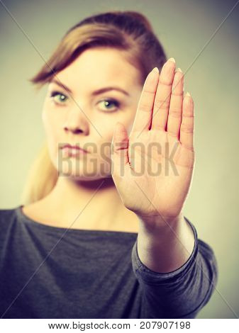Female Shows Stop Sign By Her Hand.