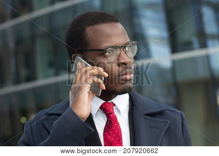 Urban Closeup Portrait Of Handsome African American Executive Standing In Street With Skyscrapers In