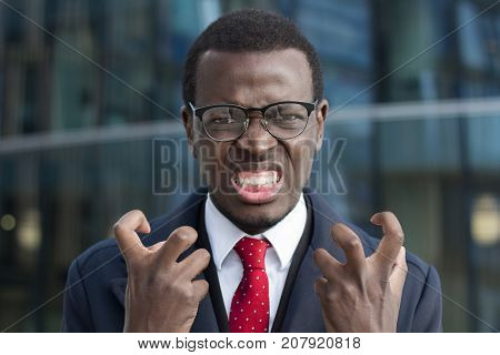 Horizontal Photo Of Young African American Businessman Pictured In City Center Looking Extremely Ten