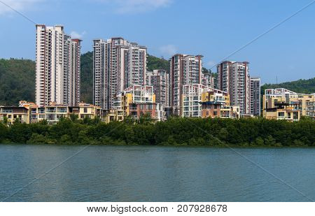 Sanya, China - April 02, 2017: Residential houses on the Linchun River bank in the city of Sanya