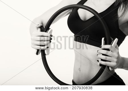 sports girl with a pilate circle on a light background.