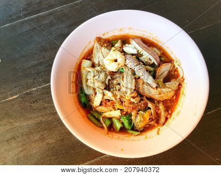 Noodles Seefood Tom Yum With Squid And Mantis Shrimp, Squid, Prawn In A Bowl On Wooden Table, Still
