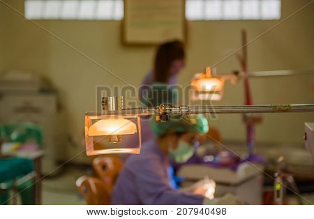 Lamps in the dental room and The doctor cares for the patient background.