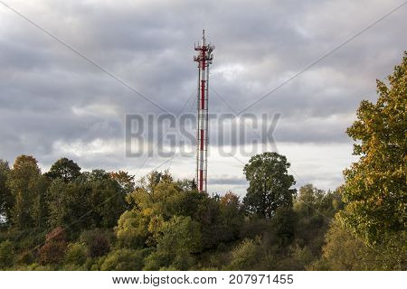 Antenna and cell phone towers on a mountaintop on a clear dayin autumn.